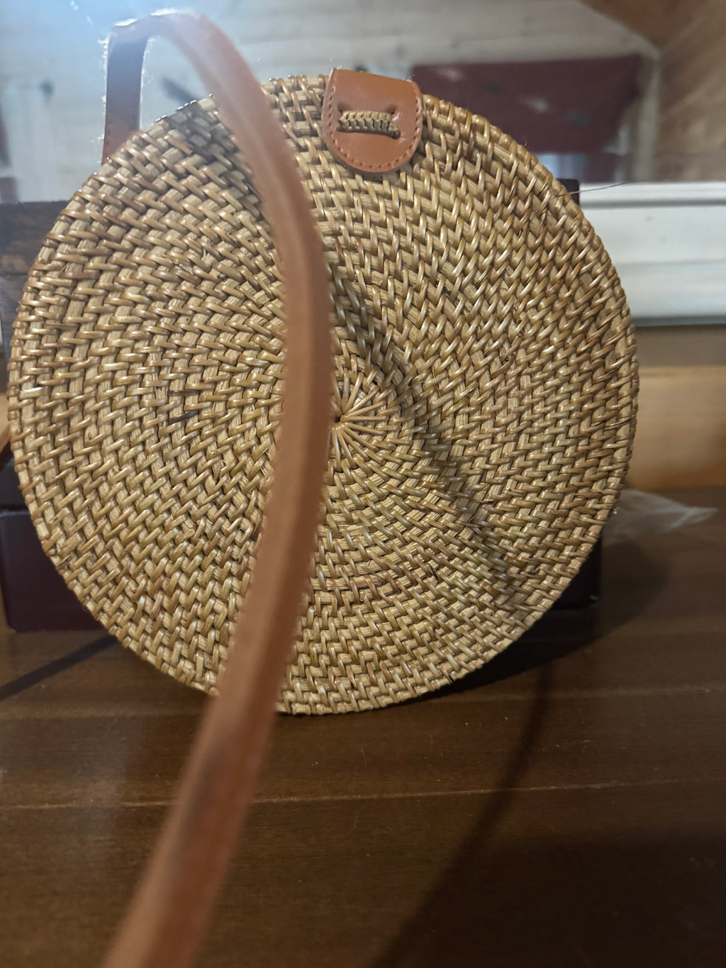 Vacation ready round woven straw crossbody with leather strap